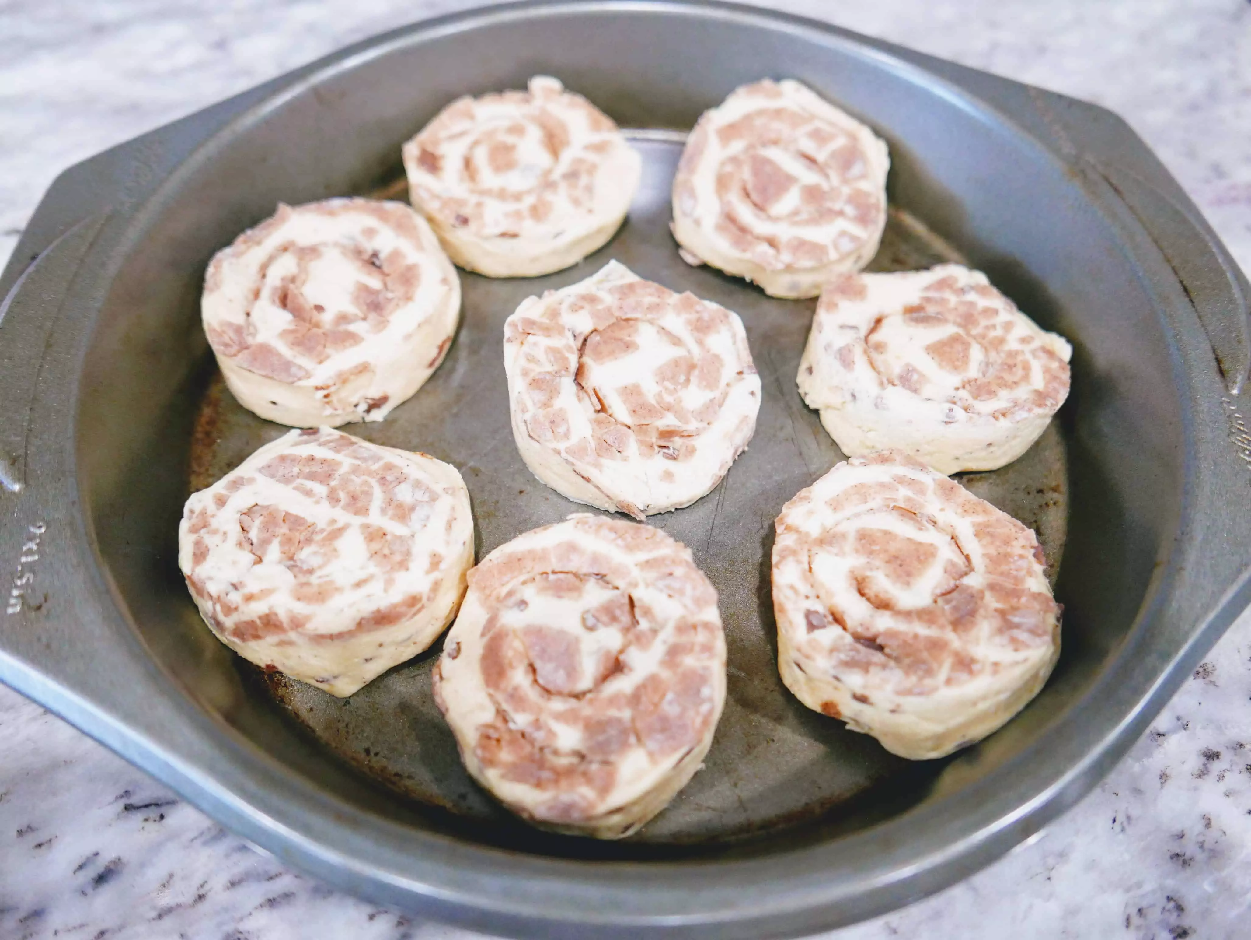 uncooked cinnamon rolls in pan
