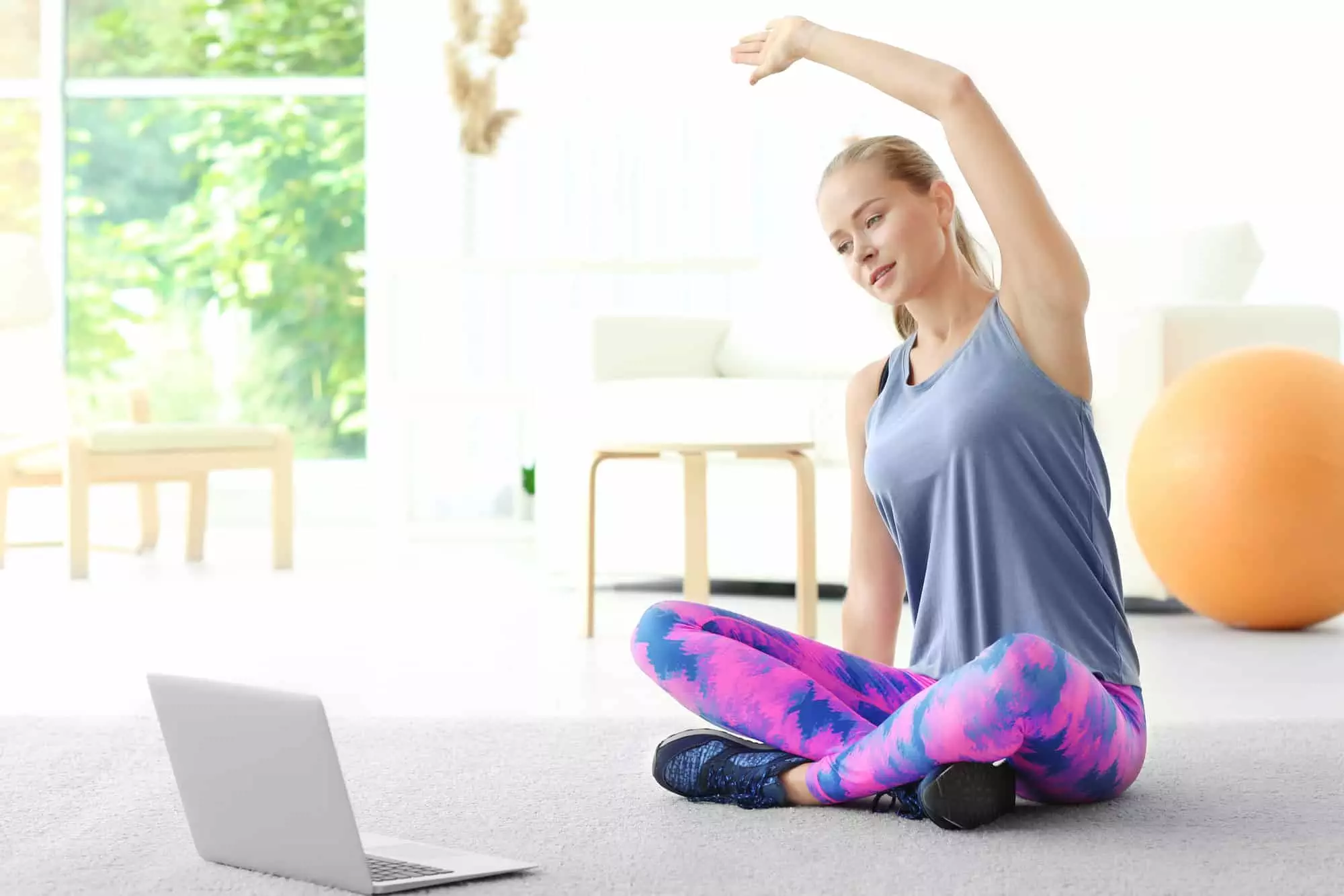 woman stretching while following a workout online