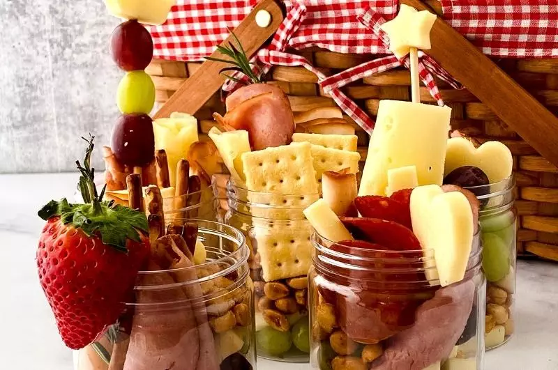 picnic basket with jars filled with charcuteries