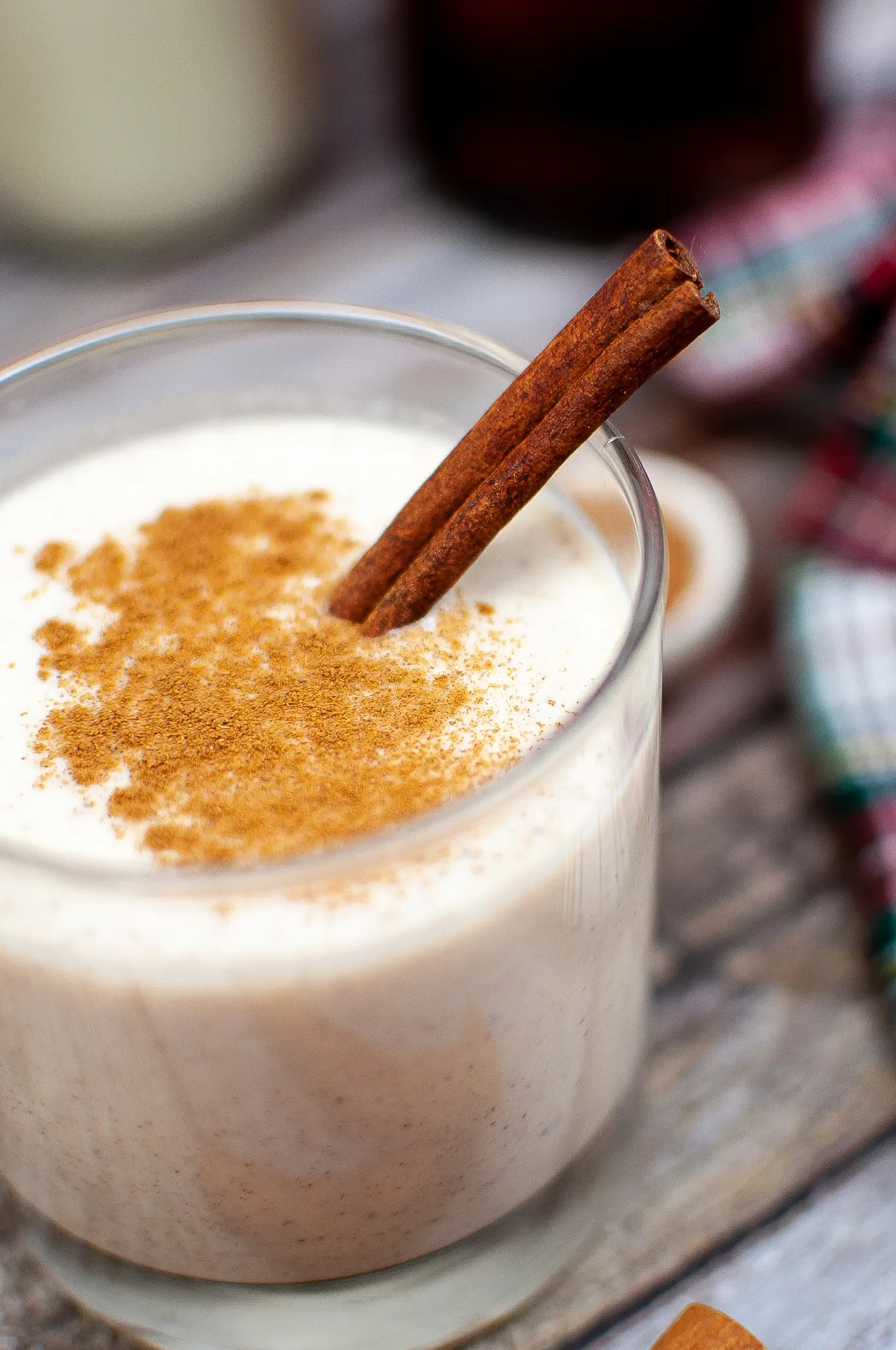 non-alcoholic eggnog recipe in a glass with cinnamon sticks