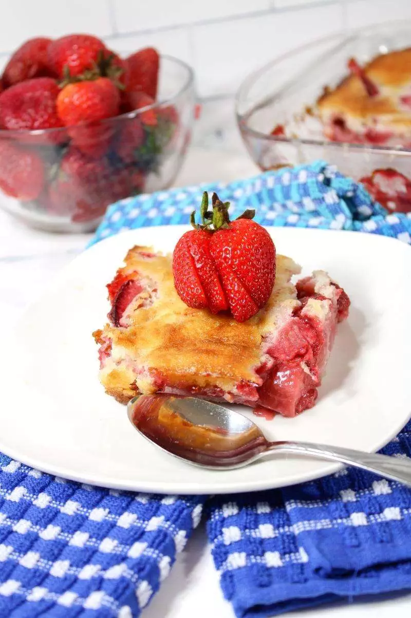 strawberry cobbler on plate with a spoon