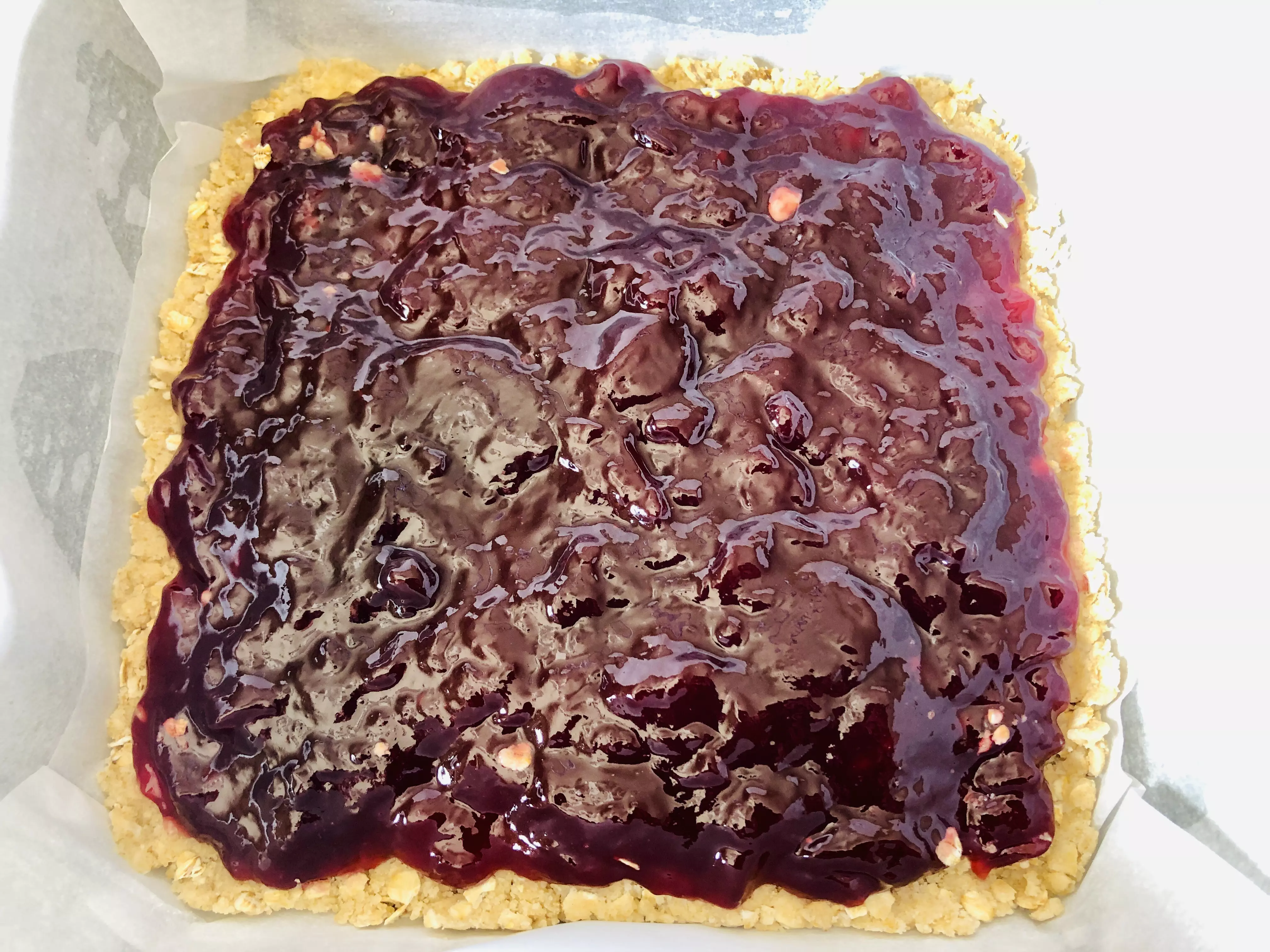 spreading jam on crust layer