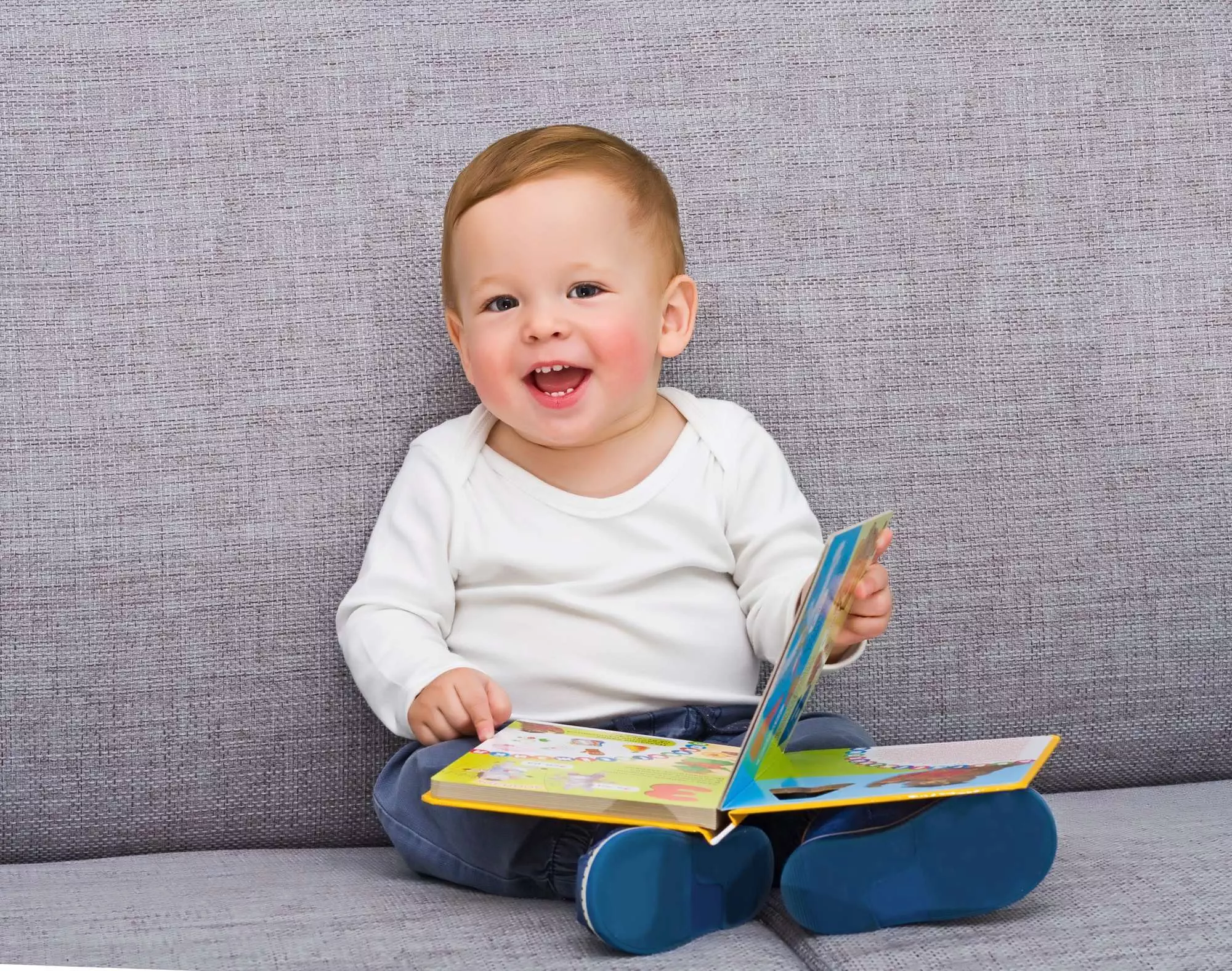 toddler with a book on their lap