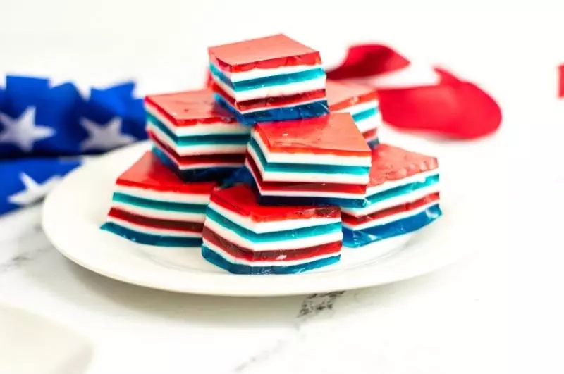 stacked red white and blue jello squares on a plate