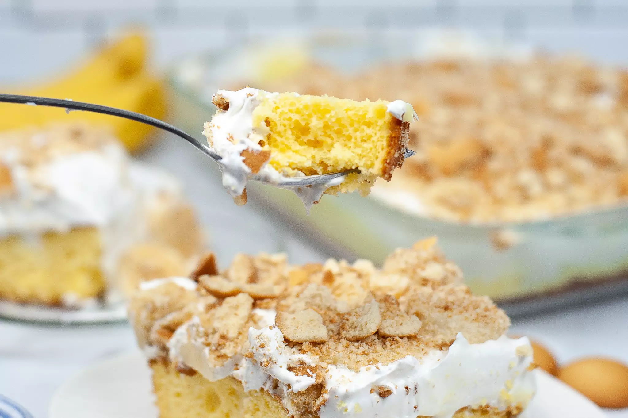 closeup of bite of banana pudding poke cake