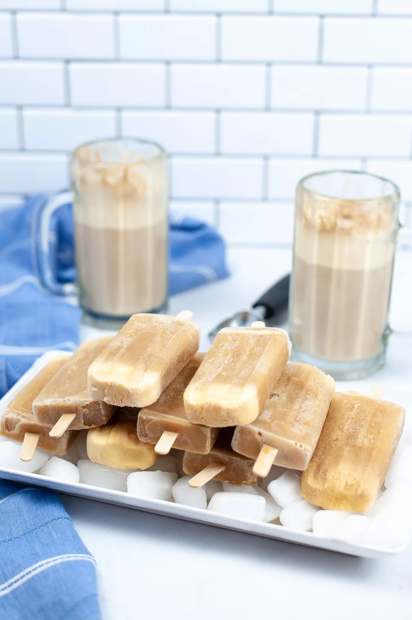 stacked root beer float popsicles on a tray