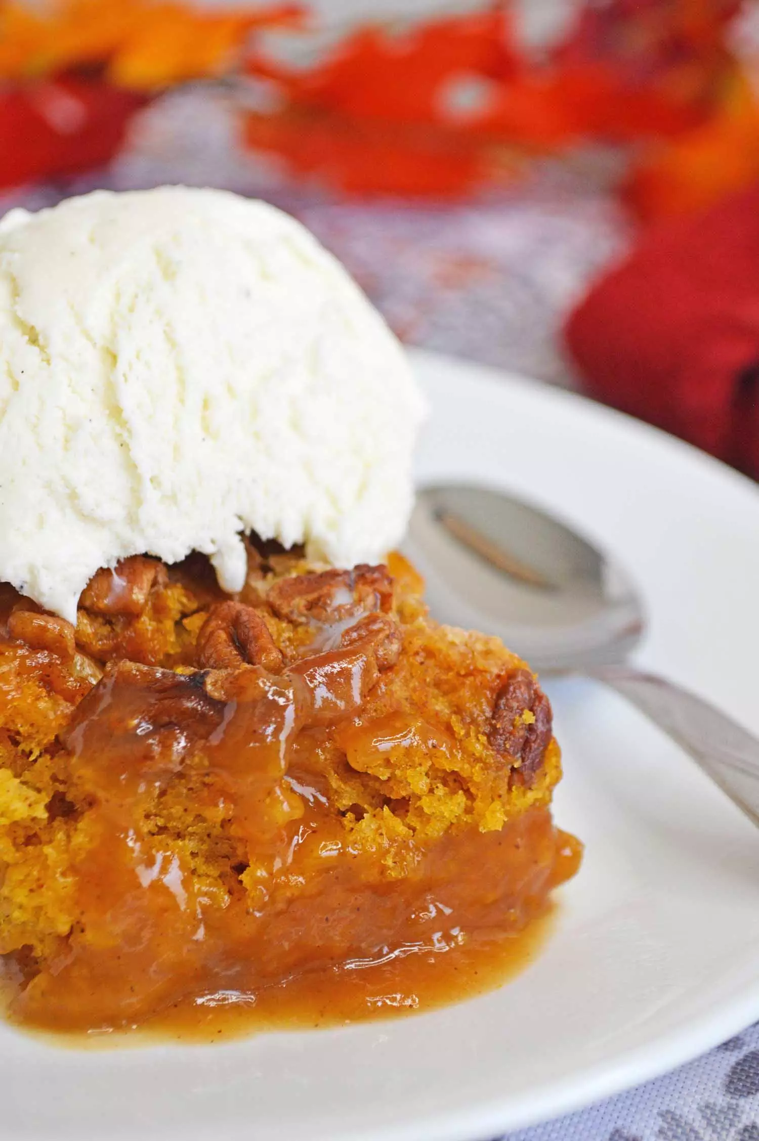 pumpkin upside down cake on a plate with ice cream