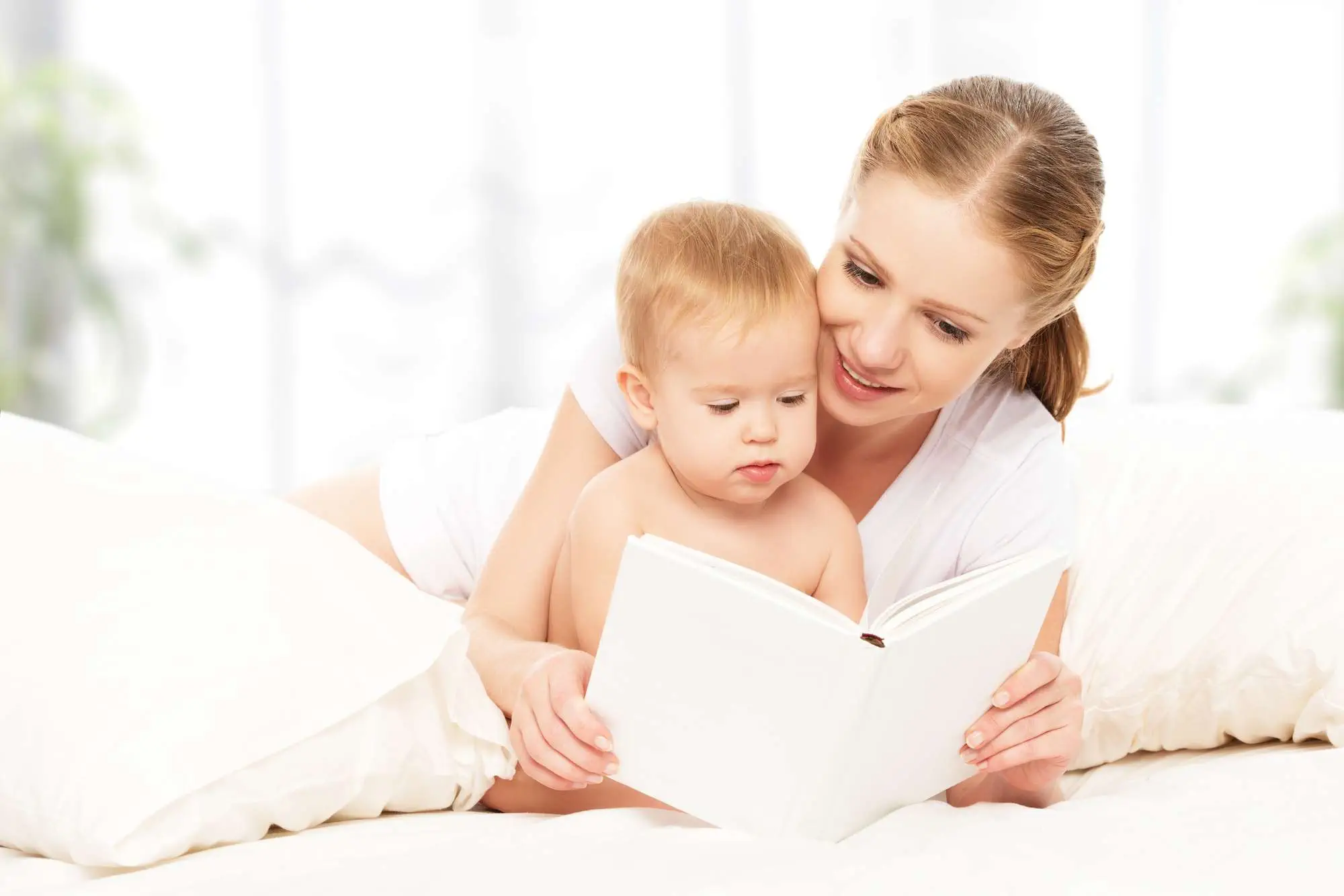 mom reading book to baby