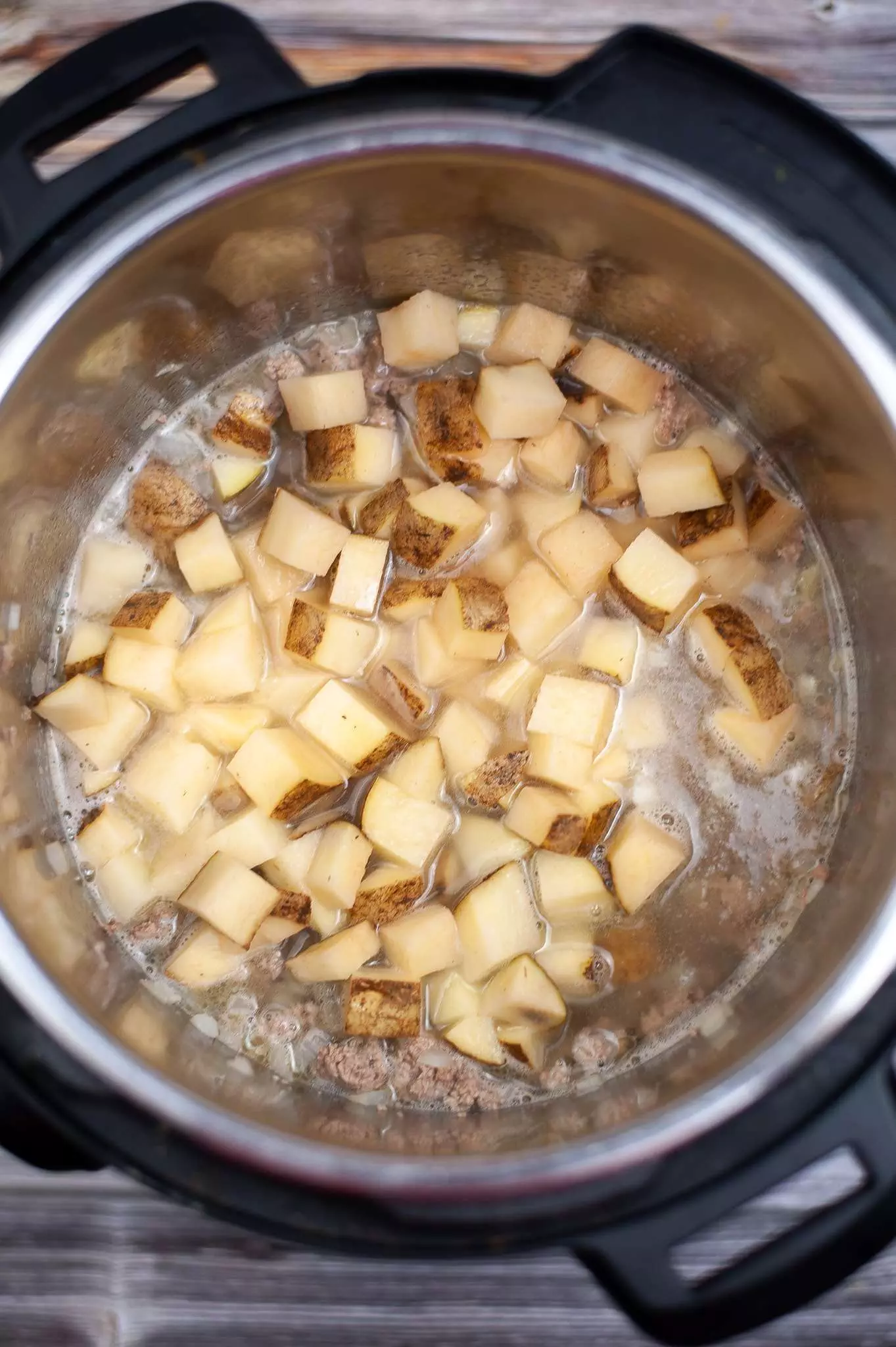 adding potatoes to the pot