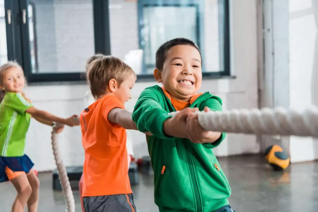 kids playing tug of war - accepting challenges is part of fostering a growth mindset for kids