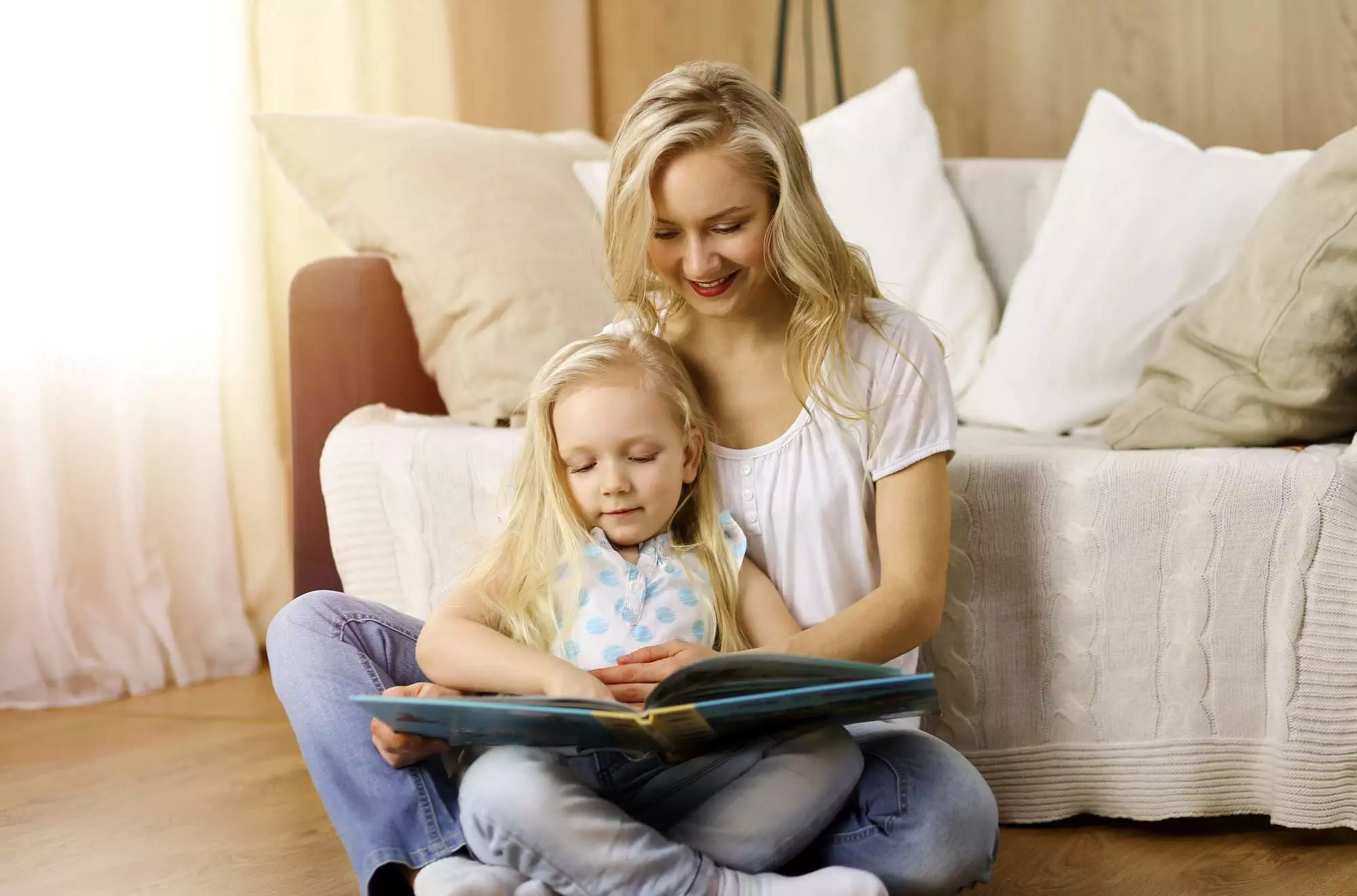 mom and toddler sitting with a book