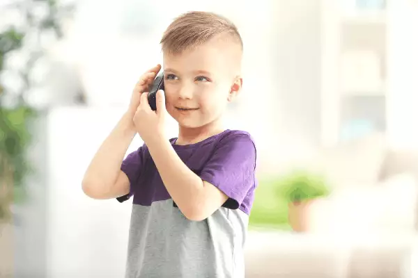 Little boy alone on the phone