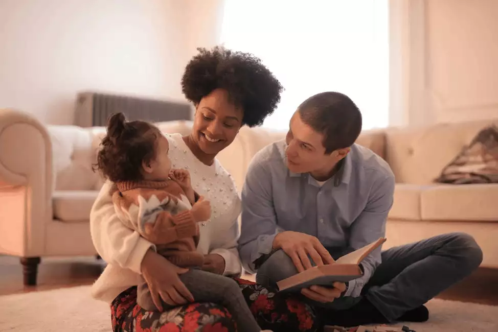 parents reading to a young girl