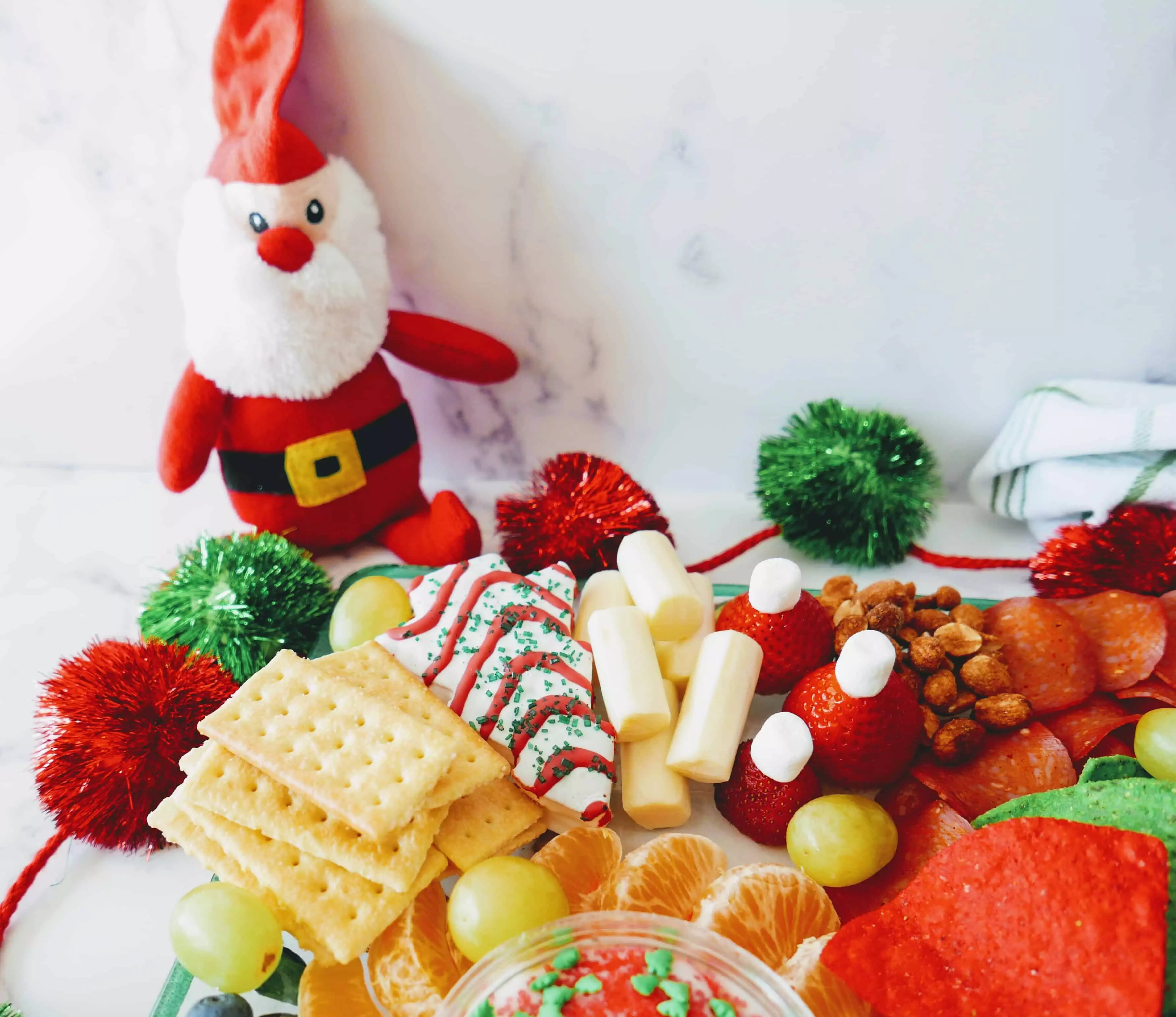 holiday charcuterie board with stuffed Santa