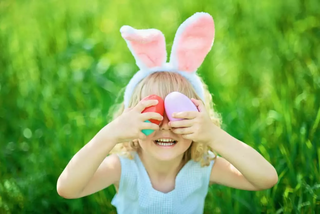 girl laughing at Easter egg scavenger hunt