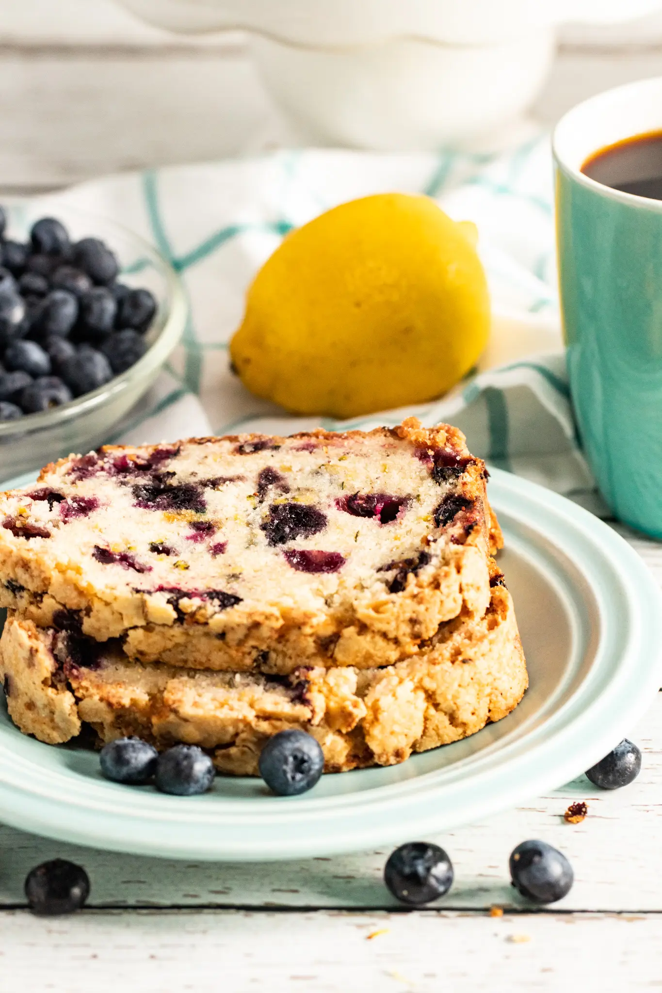 slices of lemon blueberry zucchini bread stacked on a plate