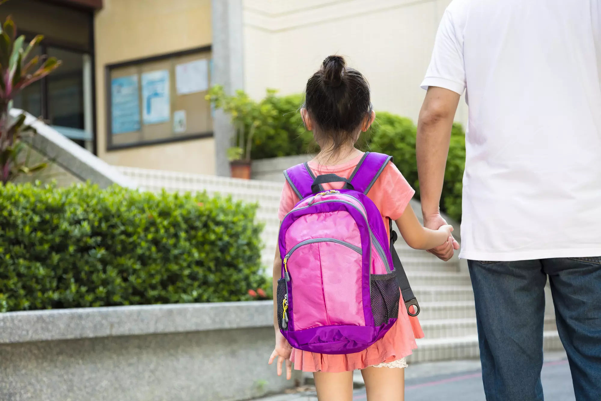 back-to-school preparation tips - dad walking girl to school on the first day