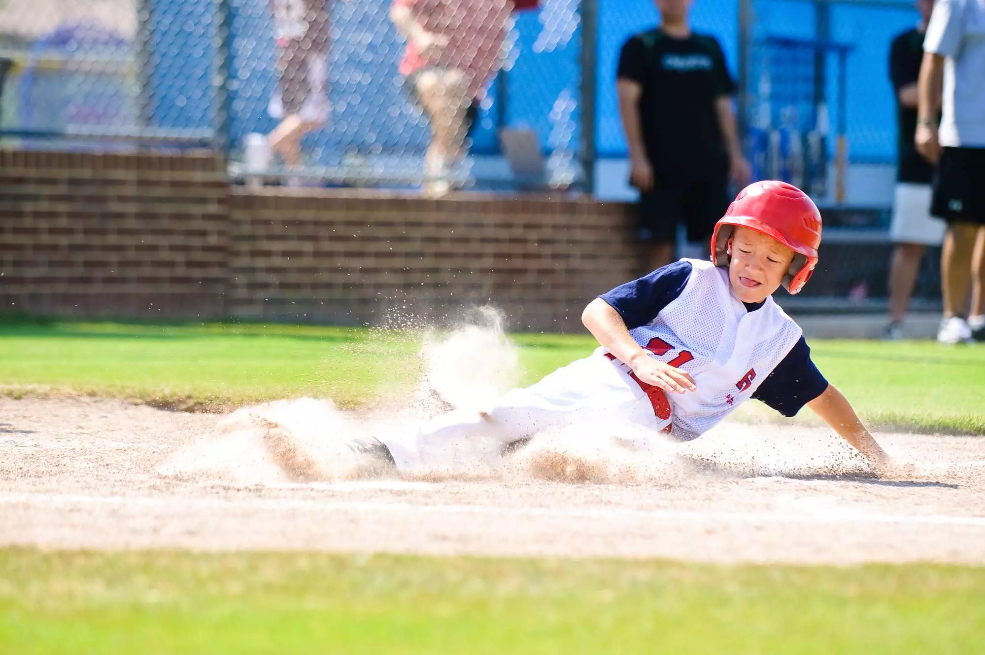 sliding into base during baseball tournament