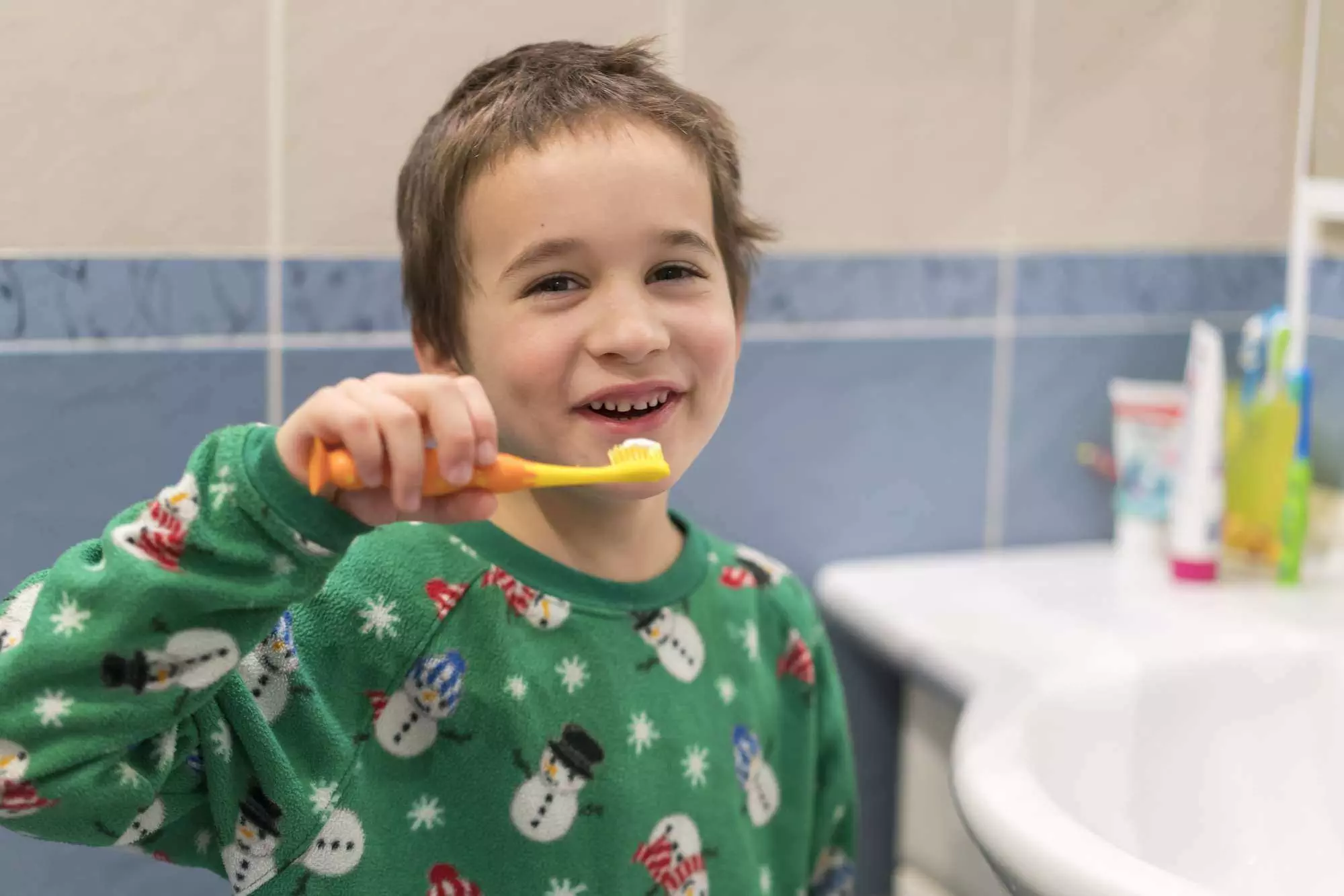 boy brushing teeth as morning routine for school