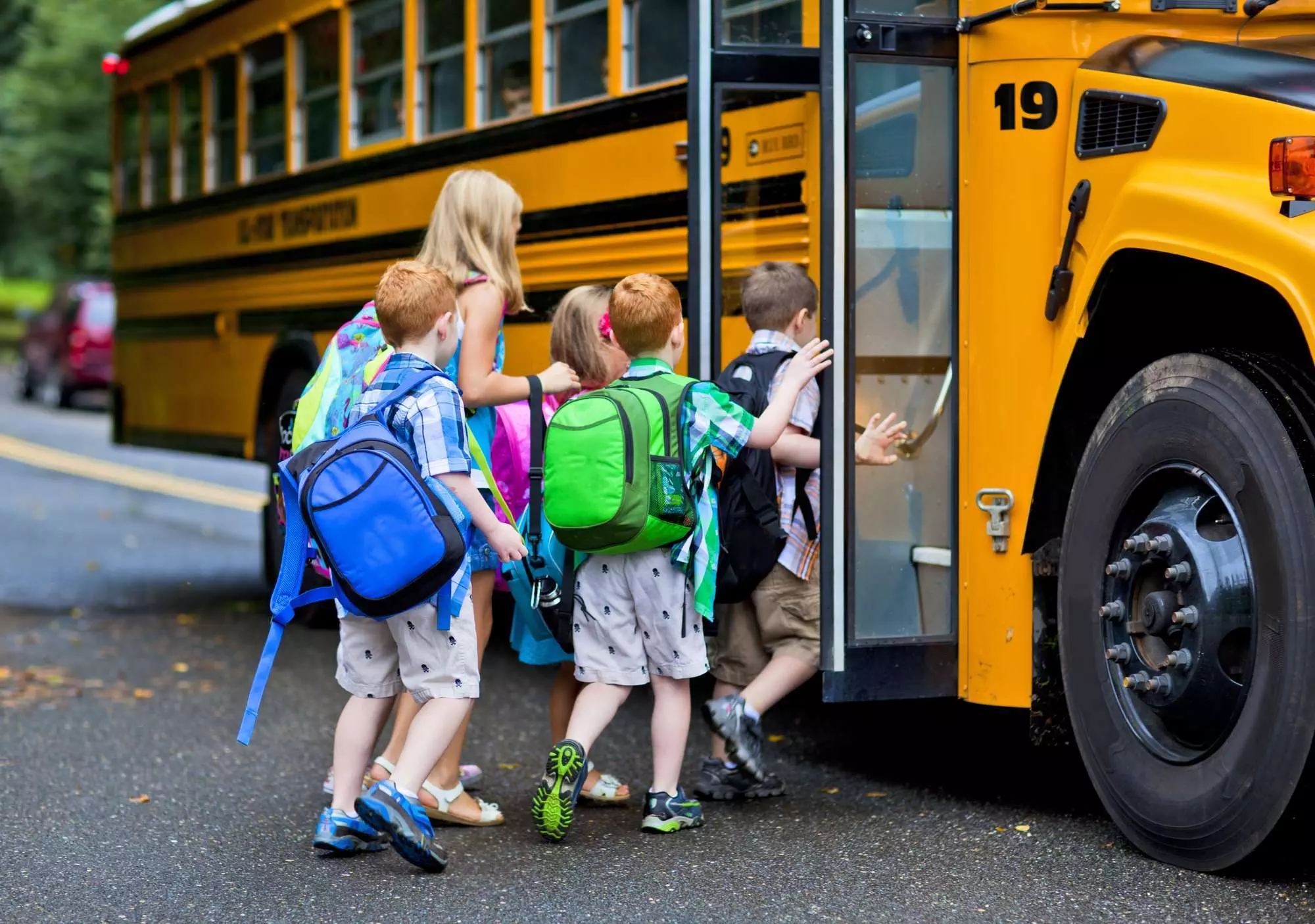 kids getting on the school bus as part of their morning routine for school