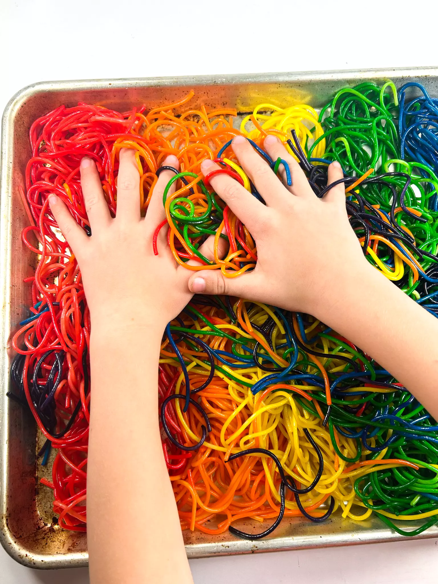 mixing colors of rainbow spaghetti
