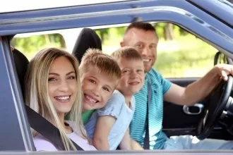 family in car for a road trip
