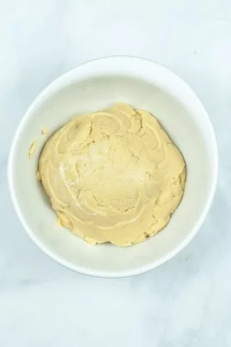 cake mixed with cream cheese in a bowl